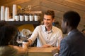 Caucasian barista serving coffee to black girl during date Royalty Free Stock Photo