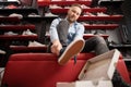 caucasian bearded man chooses hiking shoes while sitting in fitting room of modern sports store. Puts on shoes and Royalty Free Stock Photo