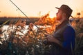 The first joint fishing of adult father and teen son in warm, sunny day. Royalty Free Stock Photo