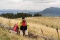 Caucasian bearded man working on his computer at the top of the mountain. Remote work concept. Royalty Free Stock Photo