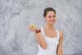 Caucasian beautiful healthy athletic sportive girl eat green apple after the training and looking at camera Royalty Free Stock Photo