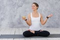 Caucasian beautiful healthy athletic sportive girl eat green apple after the training and looking at camera Royalty Free Stock Photo