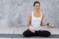 Caucasian beautiful healthy athletic sportive girl eat green apple after the training and looking at camera Royalty Free Stock Photo