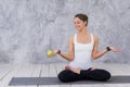 Caucasian beautiful healthy athletic sportive girl eat green apple after the training and looking at camera Royalty Free Stock Photo