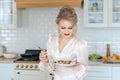 Caucasian beautiful woman preparing fresh salad ripe strawberries and arugula