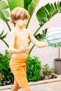 Caucasian blond boy, 9 years old, playing soccer, throwing a ball floating in front of his eyes, outdoors. Vertical Royalty Free Stock Photo