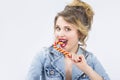 Caucasian Blond Girl Eating Big Red-Yellow Candy Cane Royalty Free Stock Photo