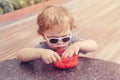 Caucasian blond preschool boy with sunglasses eating cereal meal food Royalty Free Stock Photo
