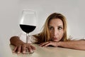 Caucasian blond wasted depressed alcoholic woman drinking red wine glass alcohol addiction