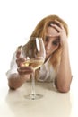 Caucasian blond wasted and depressed alcoholic woman drinking white wine glass desperate drunk