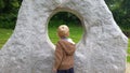 Caucasian Blonde Boy looking through sculpture Royalty Free Stock Photo