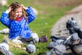 Caucasian blonde little girl feeding pigeons in a park on a sunny day. Royalty Free Stock Photo