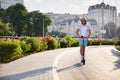 Caucasian blonde man riding electric scooter against cityscape Royalty Free Stock Photo