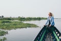 Caucasian blonde woman having a boat ride on Inle lake, Myanmar Royalty Free Stock Photo