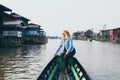 Caucasian blonde woman having a boat ride on Inle lake, Myanmar Royalty Free Stock Photo