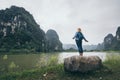 Caucasian blonde woman overlooking limestone mountains in Ninh Binh province, Vietnam