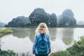 Caucasian blonde woman overlooking limestone mountains in Ninh Binh province, Vietnam