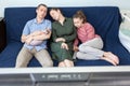 Caucasian bored family fell a sleep while watching movie at home on weekend, father, mother, teen age daughter and their sphynx Royalty Free Stock Photo