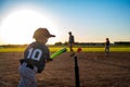 Caucasian boy with baseball bat at home plate swinging at ball on tee Royalty Free Stock Photo