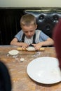 Little boy learning how to make dumplings Royalty Free Stock Photo