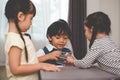 Caucasian boy fighting for toys with her sisters. Family and children concept. Conflict and quarrel theme. Thee people in home Royalty Free Stock Photo