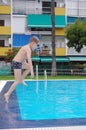 Boy jumping in cool water of swimming pool Royalty Free Stock Photo