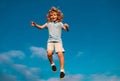 Caucasian boy in a park running and smiling on blue sky. Happy kid laughing. Emotion face joy child. Joyful, funny Royalty Free Stock Photo