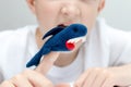 A caucasian boy playing different roles by using finger puppets, toys for expressing his emotions, agression, fear and freandship Royalty Free Stock Photo