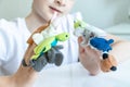 A caucasian boy playing different roles by using finger puppets, toys for expressing his emotions, agression, fear and freandship Royalty Free Stock Photo