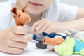A caucasian boy playing different roles by using finger puppets, toys for expressing his emotions, agression, fear and freandship Royalty Free Stock Photo