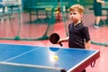 Caucasian boy playing table tennis at the blue table Royalty Free Stock Photo