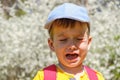 Caucasian boy portrait crying while standing up in park