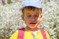 Caucasian boy portrait crying while standing up in park