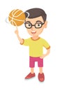 Caucasian boy spinning basketball ball on finger.