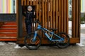 Caucasian boy is tired from cycling and is resting Royalty Free Stock Photo