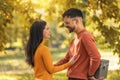 Caucasian boyfriend give box gift to lovely pretty girlfriend in autumn park