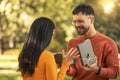 Caucasian boyfriend give box gift to lovely pretty girlfriend in autumn park