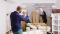 Caucasian boyfriend telling his girlfriend how to hang picture in the wall Royalty Free Stock Photo