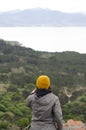 Caucasian brunette girl in orange hat and gray jacket. Royalty Free Stock Photo