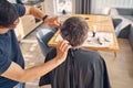 Man sitting in front of the table and getting new haircut Royalty Free Stock Photo