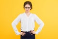 Portrait of confident beautiful young serious disappointed elegant business woman on yellow background