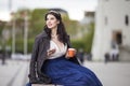 Caucasian Brunette Woman Drinking Tea or Coffee In The City Center Outdoors Royalty Free Stock Photo