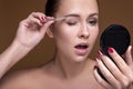 Caucasian brunette woman tweeze her eyebrowns. Close up portarait. Skin care  concept Royalty Free Stock Photo