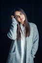 Caucasian brunette young beautiful girl woman model with dark hair and brown eyes in white shirt and grey long coat Royalty Free Stock Photo