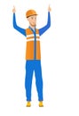 Caucasian builder standing with raised arms up.