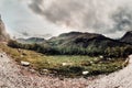 Caucasian bulls and cows on the mountain pastures in the tract near Mount Elbrus on a background of beautiful rocks Royalty Free Stock Photo