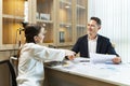 Caucasian business CEO congratulate female employee for the outstanding achievement of her team performance by shaking hand in the Royalty Free Stock Photo