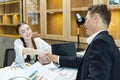 Caucasian business CEO congratulate female employee for the outstanding achievement of her team performance by shaking hand in the Royalty Free Stock Photo