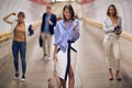 Caucasian business colleagues walking through pedestrian underground tunnel with fists up, gesturing Royalty Free Stock Photo