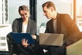 Caucasian business couple having business conversation together in office Royalty Free Stock Photo